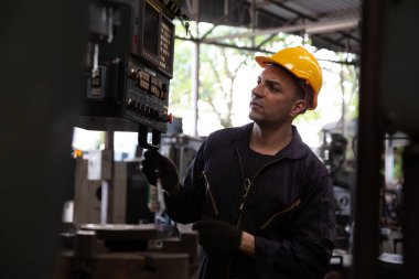 Ağır endüstriyel işçiler metal fabrikası, çelik yapı endüstrisi konsepti için makine üzerinde çalışıyorlar.