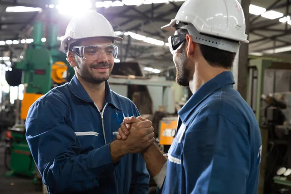 重工业工人头戴手套 在金属工厂 团队合作及合作概念上互相握手致意 — 图库照片