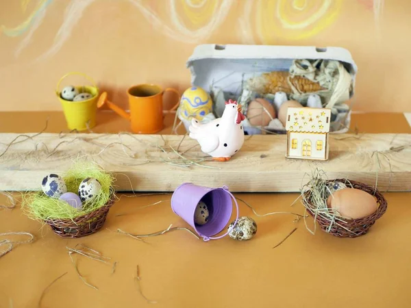 Easter decor, eggs, toy chicken on a light wooden table