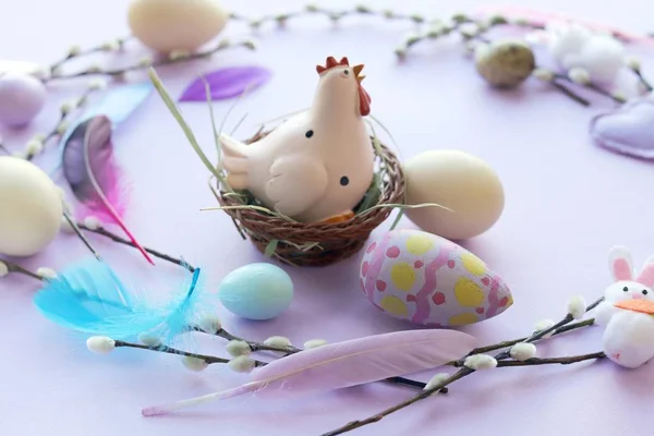 Easter decoration, toy chicken, eggs, pussy-willow twigs on a  windowsill, spring, festive home decor