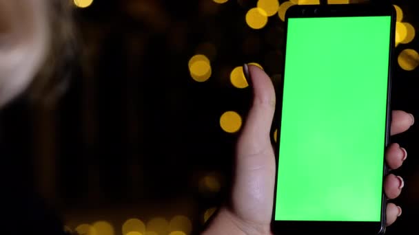 Female hand holds mobile phone with chromakey vertical green screen mockup pov — Stok video