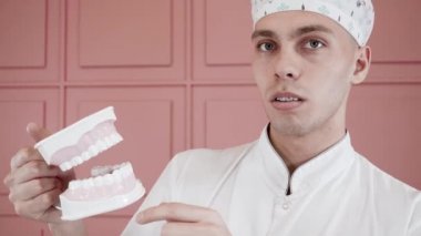 Portrait of a young guy smiling with braces and snapping a implant of the jaw.
