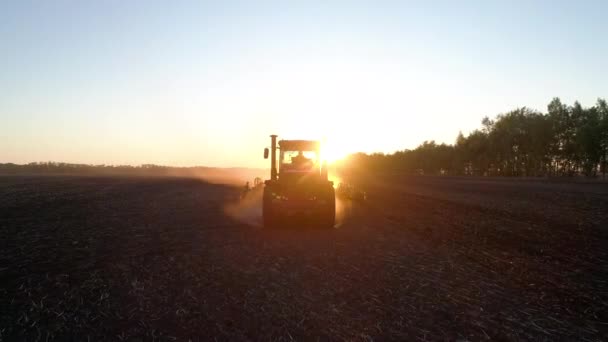 Landbouwwerkzaamheden op het platteland met betrekking tot de trekker op het landbouwterrein van de natuurboerderij door de landbouwer — Stockvideo