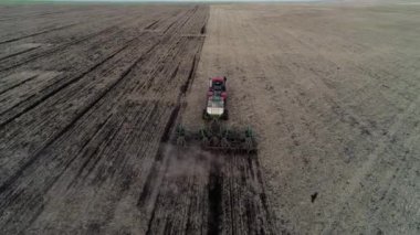 Aerial view of rural industry, farming work by agriculture machine on field farm