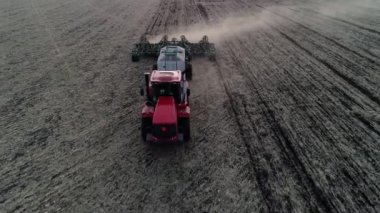 Farming work by tractor or agriculture machine on rural farm, industry field