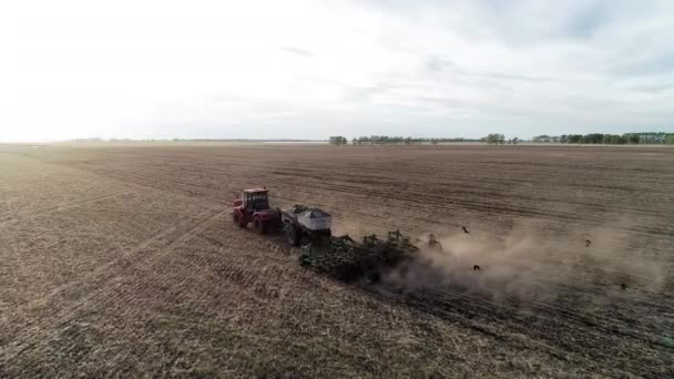 Aerial view of industry farming work on field, farm land by agriculture machine — Stock video