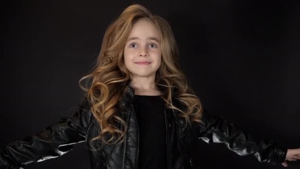 Smiling dancing little girl look camera, lively emotions of beauty fashion child — Stockvideo