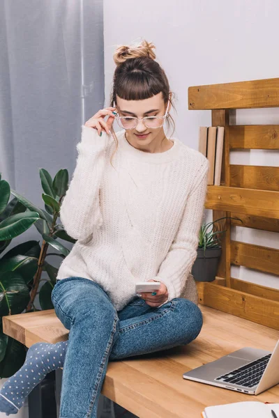 Girl Sitting Table Office Looking Smartphone — Free Stock Photo