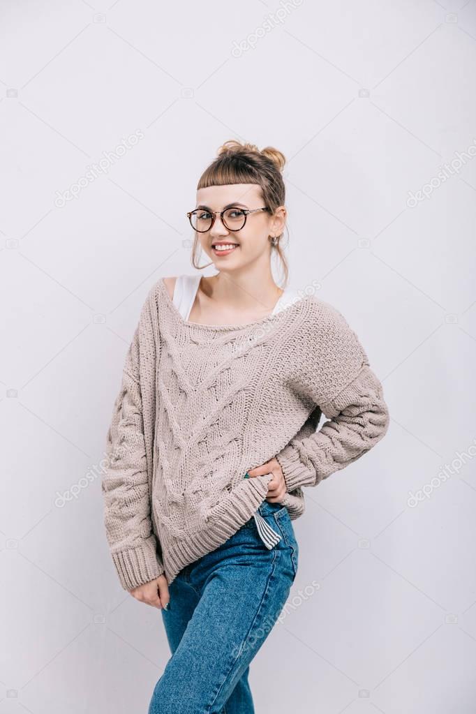 smiling girl in glasses posing isolated on white