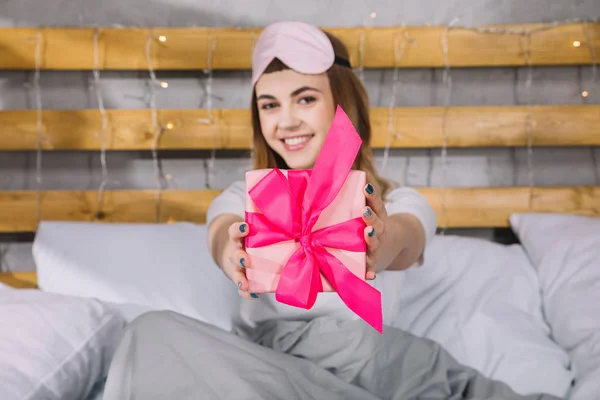 Happy Girl Sitting Bed Showing Present Box — Free Stock Photo