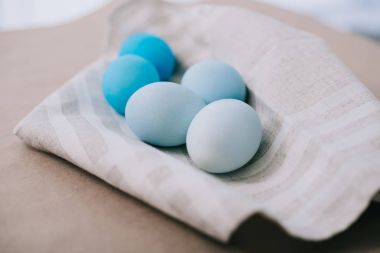 close-up shot of blue shades easter eggs on napkin clipart