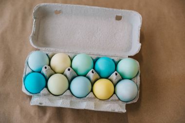 top view of colored easter eggs in cardboard pack clipart
