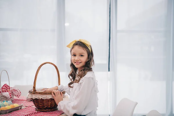 Little Child Basket Looking Camera Table Easter Eggs — Free Stock Photo