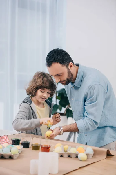 Concentrated Young Father Son Painting Easter Eggs Royalty Free Stock Photos