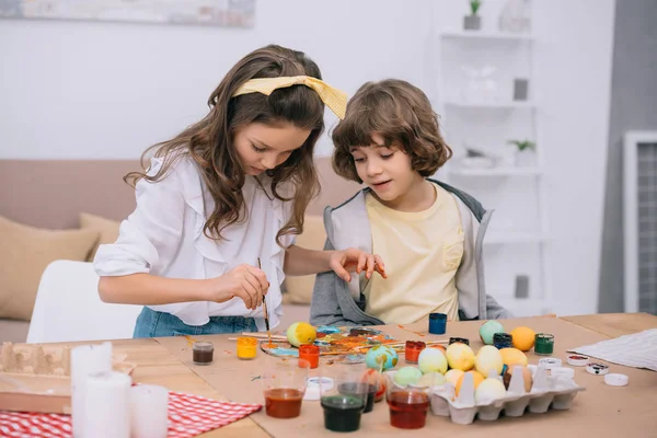 Concentrated Little Kids Painting Easter Eggs Together Stock Photo