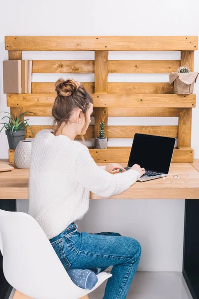 Girl working with laptop in modern office — Stock Photo