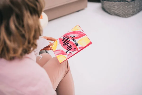 Cropped shot of kid presenting mothers day greeting card for mother — Stock Photo