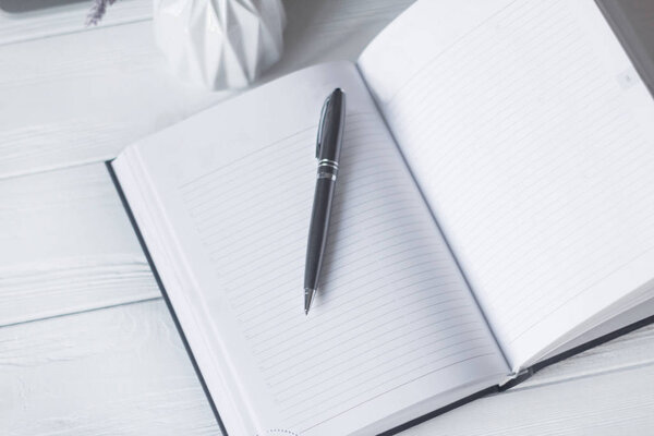 pen and a notebook at the workplace