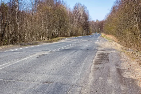 Broken out-of-town asphalt road