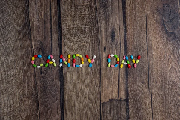 Words Candy Day from small sweeties in multi-colored glaze