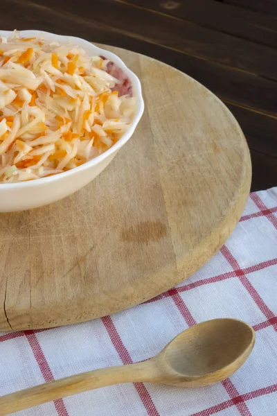 Healthy Russian dish sauerkraut with carrots in a deep plate