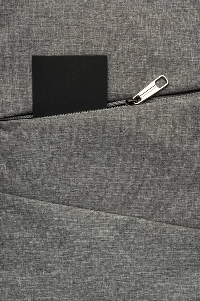 Black Card Peeks Out Zipper Pocket Gray Textured Fabric Background — Stock Photo, Image