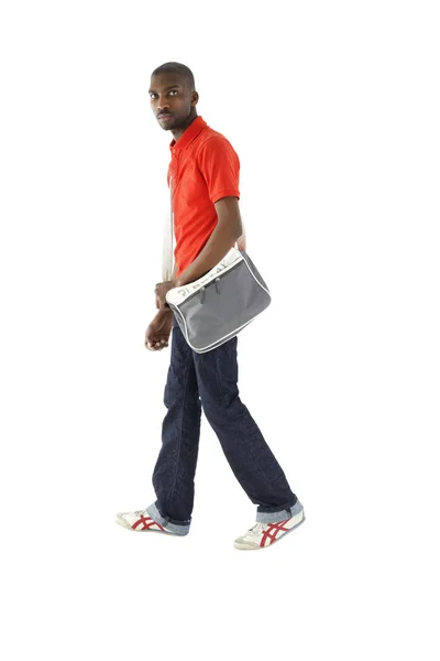 African male wearing a red shirt, denim jeans and has a shoulder Stock Picture