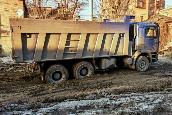 En stor smutsig lastbil är i staden på en byggarbetsplats — Stockfoto