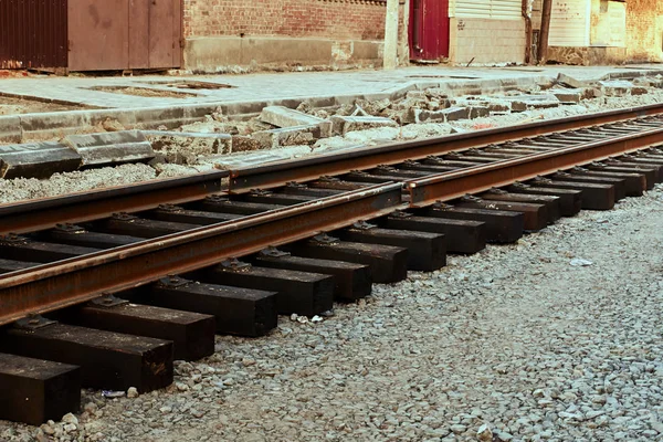 New rails and wooden sleepers are prepared for laying on gravel — Stock Photo, Image