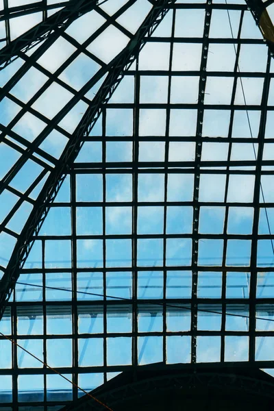 Glass ceiling overlooking the blue sky in a large shopping center and office building in a big city