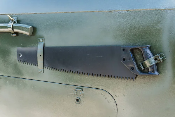 Hand-sawed wood and other tools on the back of a large green wazdick — Stock Photo, Image