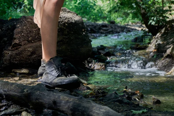 Bein av en ung jente i rare, gamle støvler under en spasertur i skogen på en varm sommerdag – stockfoto