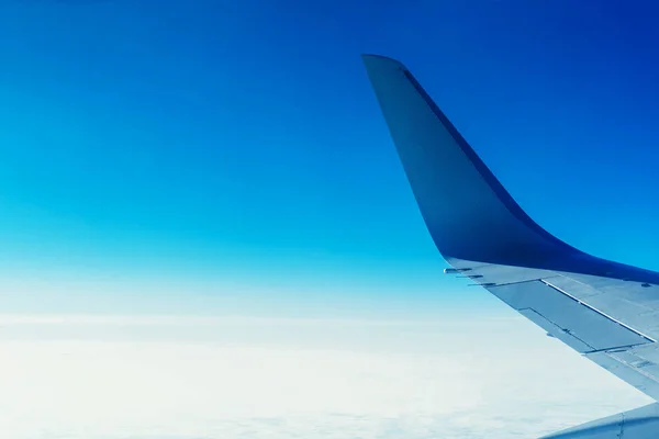 airplane winglet good video from the porthole of an airplane flying on a large elevation in the afternoon