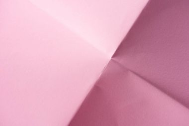 yakın çekim katlanmış pembe kağıt arka plan için vurdu.