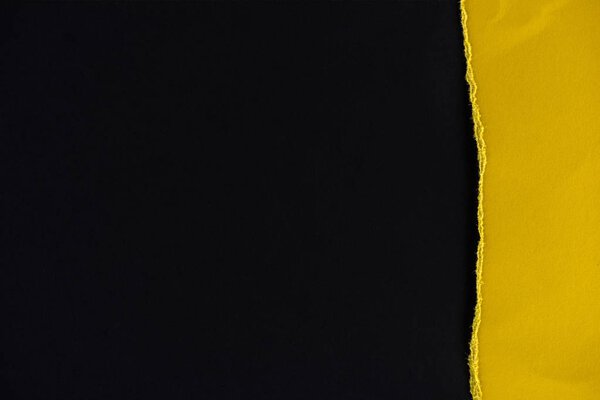 piece of yellow paper isolated on black