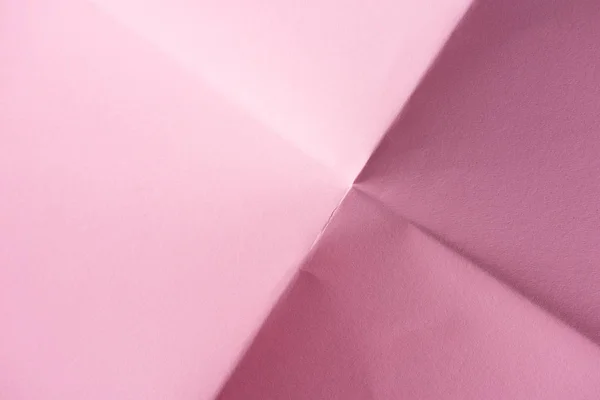 Κοντινή Λήψη Ενός Διπλωμένο Χαρτί Ροζ Φόντο — Φωτογραφία Αρχείου