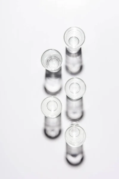 Top View Five Small Empty Glasses White Table — Stock Photo, Image