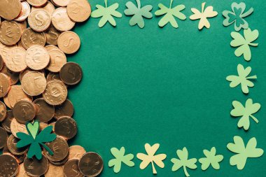 top view of shamrock and golden coins on green, st patricks day concept clipart