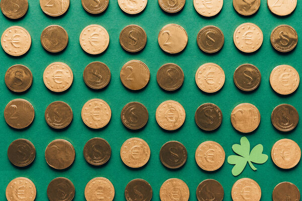 top view of pattern of golden coins and shamrock on green, st patricks day concept