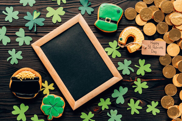 top view of empty board with gingerbread and coins on table, st patricks day concept