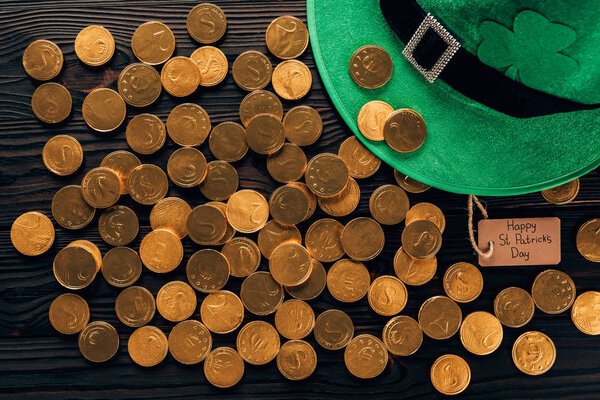top view of green hat and golden coins on table, st patricks day concept