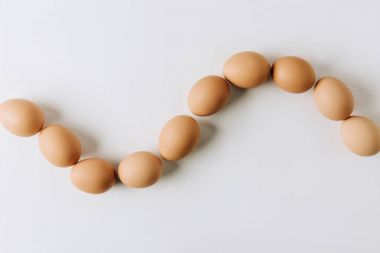 brown eggs laying on white background clipart