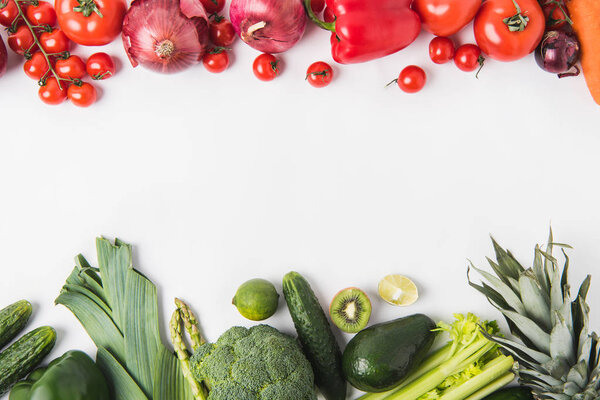 Border of green and red vegetables and fruits isolated on white background