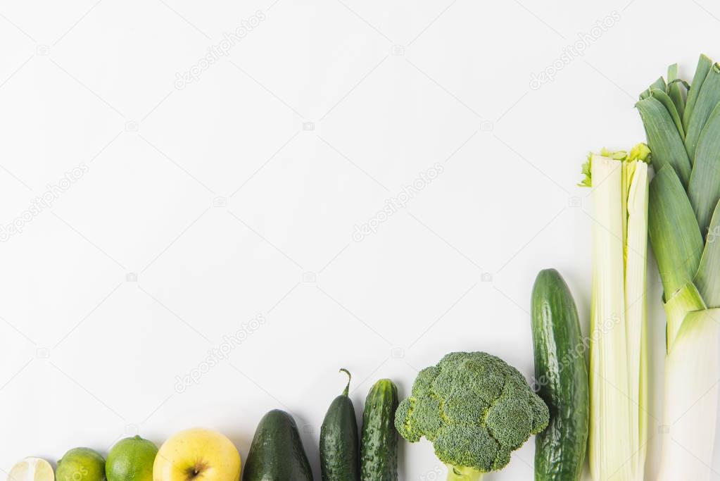 Composition of green vegetables in a row isolated on white background