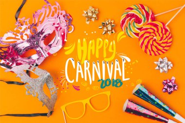 flat lay with lollipops and party objects isolated on orange, carnival concept clipart