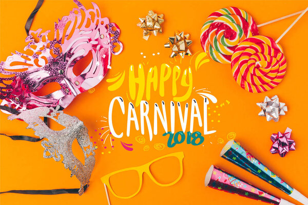 flat lay with lollipops and party objects isolated on orange, carnival concept