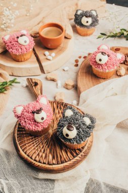 close-up view of delicious sweet cupcakes in shape of bears on table clipart
