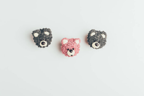 top view of sweet tasty cakes in shape of bears isolated on grey 