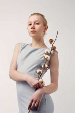 beautiful young woman with cotton branch looking at camera isolated on white clipart