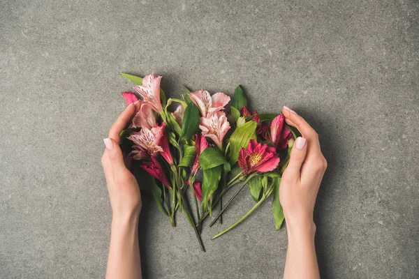 Partial View Female Hands Beautiful Peruvian Lilies Grey Concrete Tabletop — Stock Photo, Image